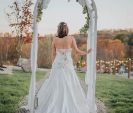 Bride under the arch facing the lake