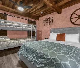 Bed and bunk bed in Daisy Hobbit-inspired cabin at Nature Mystique Retreat