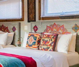 Decorative pillows on beds in Casablanca, an Alladin-inspired cabin at Nature Mystique