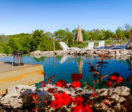 Lantern and flowers overlooking the natural swimming hole at Nature Mystique Retreat