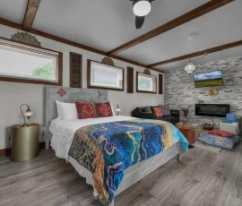 Bed in Marrakesh with living room area beyond in Aladdin-inspired cabin at Nature Mystique Retreat