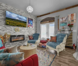 Spacious living room with electric fireplace and large-screen TV in Tangier Aladdin-inspired cabin at Nature Mystique Retreat