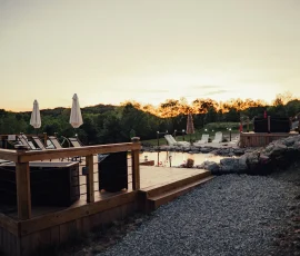 Sunset reflecting on the natural swimming hole surrounded by lush foliage at Nature Mystique Retreat