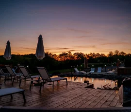 Sunset view from the deck overlooking the sandy beach and natural swimming hole at Nature Mystique Retreat