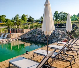 Hot tub and deck overlooking the natural swimming hole at Nature Mystique Retreat