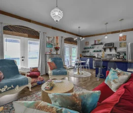View of living room facing dining area and kitchen in Tangier Aladdin-inspired cabin at Nature Mystique Retreat
