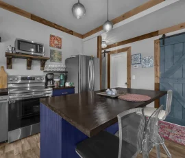 View of kitchen and island facing hallway to bedrooms in Tangier Aladdin-inspired cabin at Nature Mystique Retreat