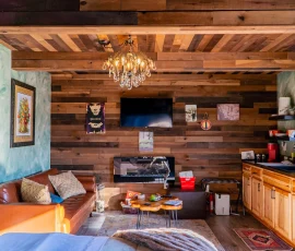 View of living room and kitchenette from bed in Forest Hobbit-inspired cabin at Nature Mystique Retreat