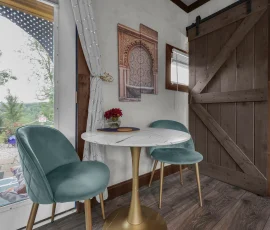 dining table with two chairs in Casablanca, an Alladin-inspired cabin at Nature Mystique