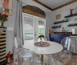 Kitchen table near double doors to balcony in Tangier Aladdin-inspired cabin at Nature Mystique Retreat