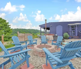 Seven chairs around firepit overlooking private cedar hot tub at Tangier Aladdin-inspired cabin at Nature Mystique Retreat