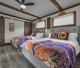 Two beds with ceiling fan in Casablanca, an Alladin-inspired bedroom at Nature Mystique Retreat